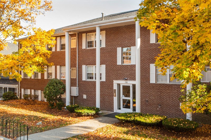 a brick building with trees in front of it