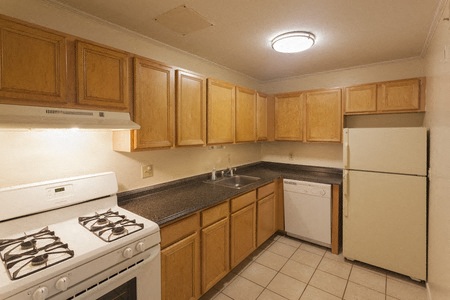 a kitchen with a stove and a refrigerator