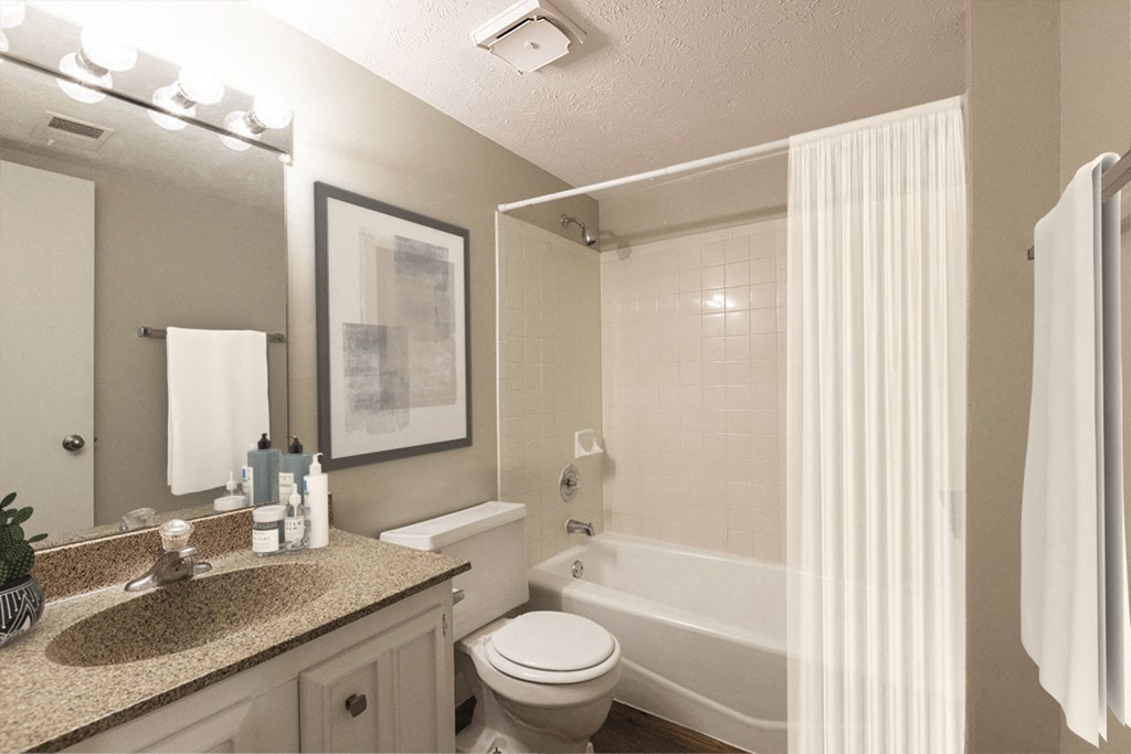 a bathroom with a white tub and a sink and a toilet