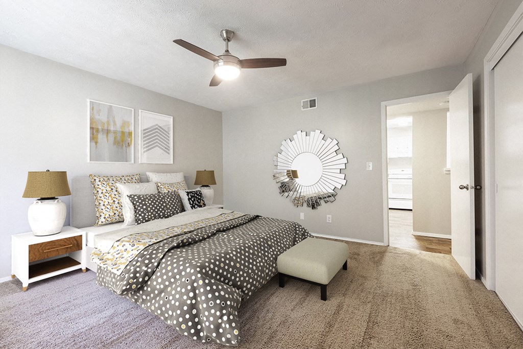 a bedroom with a bed and a ceiling fan