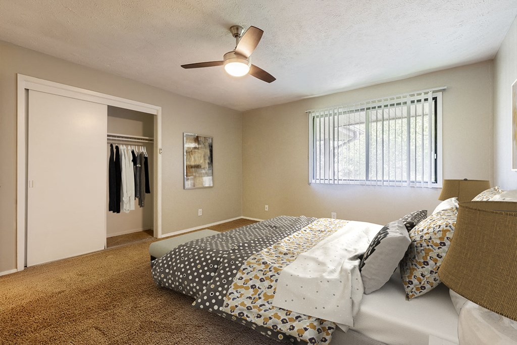 a bedroom with a bed and a ceiling fan