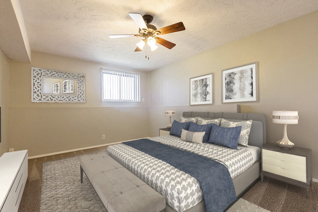a bedroom with a large bed and a ceiling fan