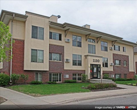 a large apartment building on the side of a street