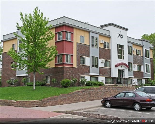 a car parked in front of an apartment building