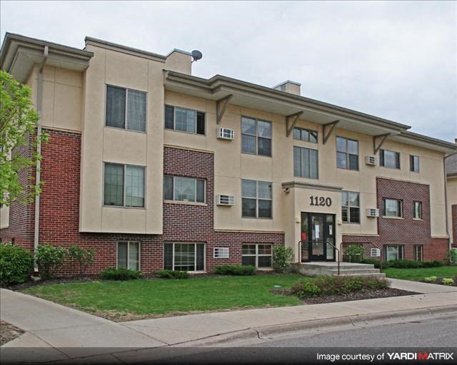 a large apartment building on the side of a street