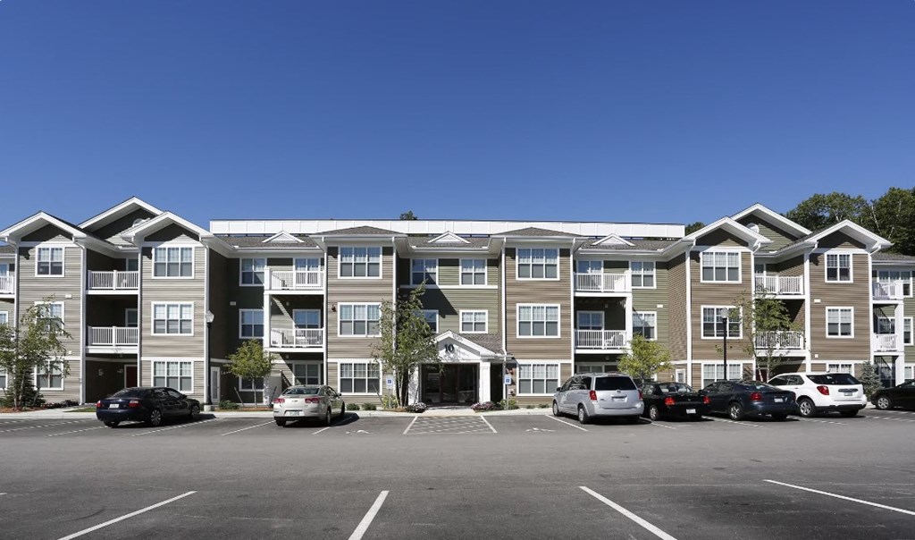 a parking lot in front of an apartment building