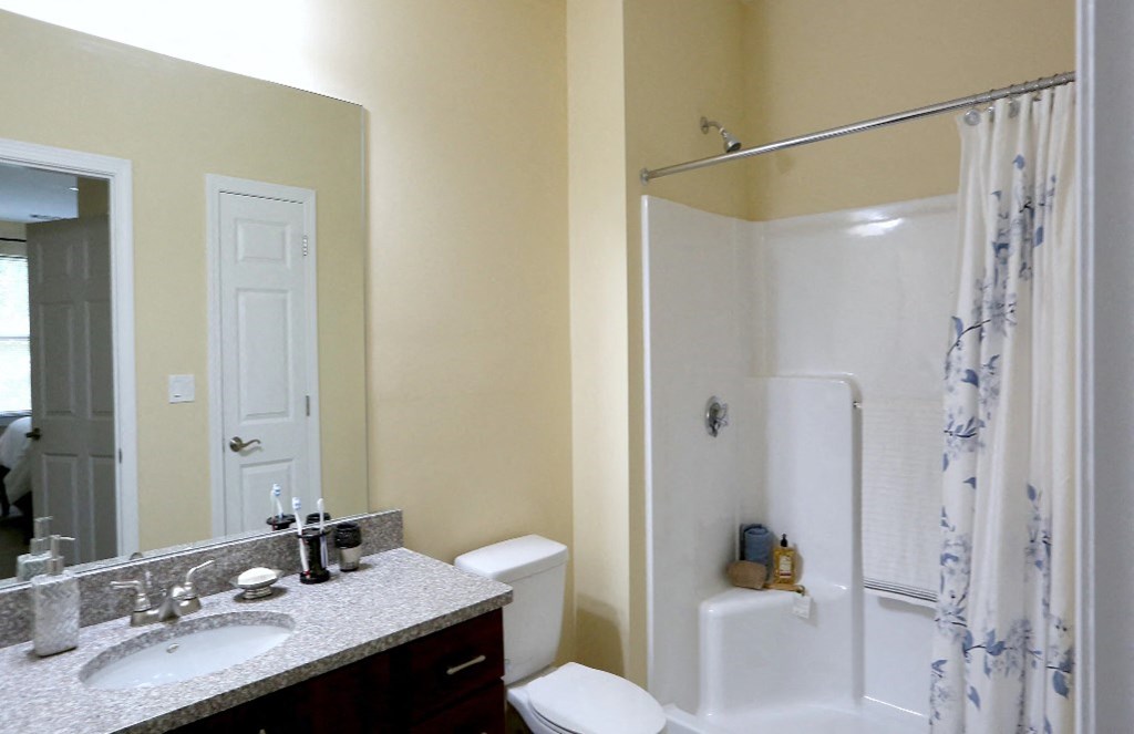 a bathroom with a sink toilet and a shower