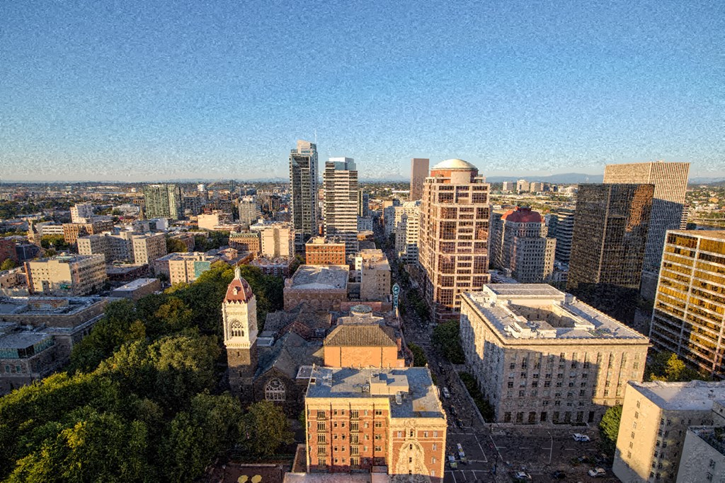 an aerial view of a city with tall buildings and trees