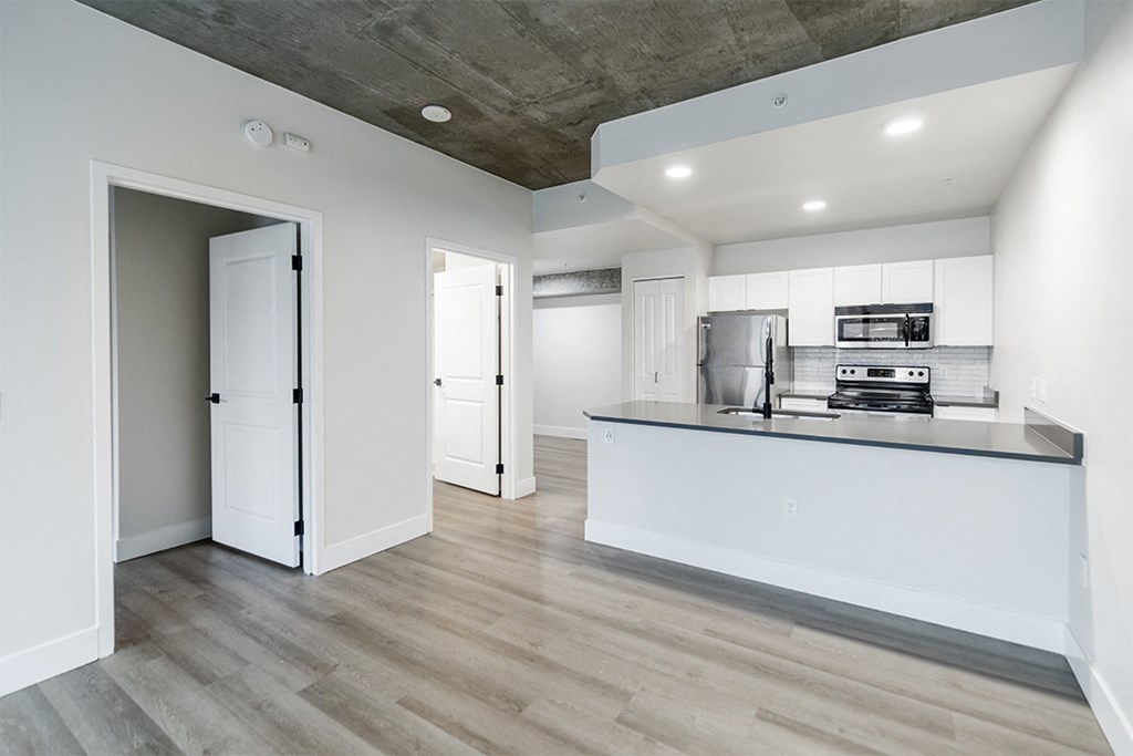 a kitchen with white cabinets and a counter top