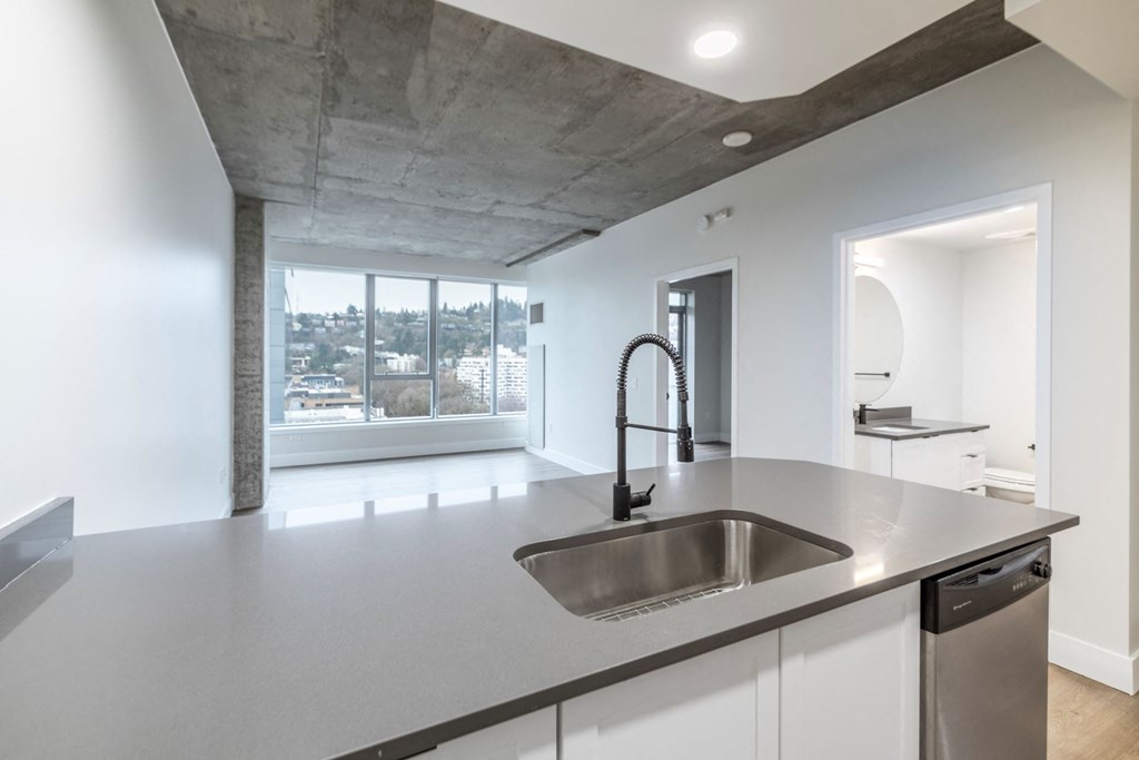 a kitchen with a sink and a large window
