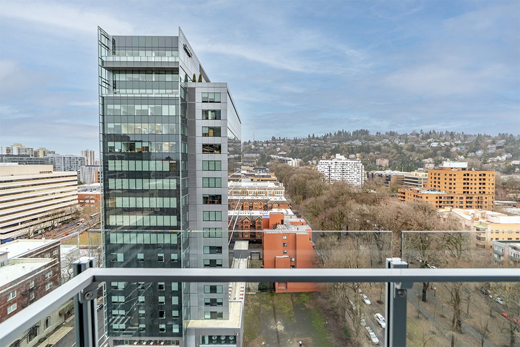 a view of the city from a balcony on a sunny day