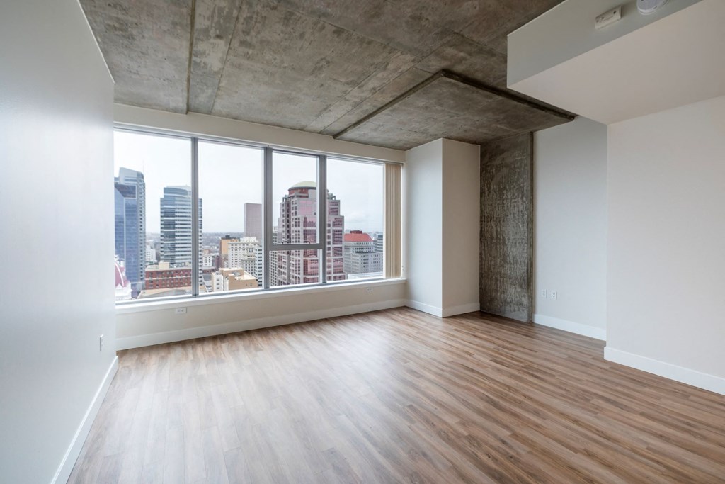 an empty living room with a view of the city