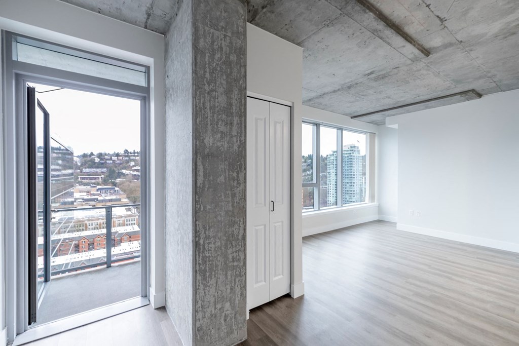 a living room with a door and a view of the city