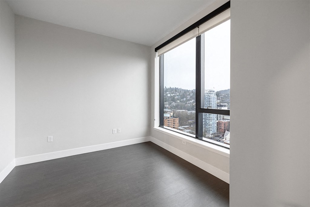 an empty living room with a large window