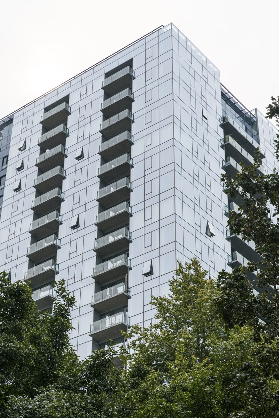 a tall building with trees in front of it