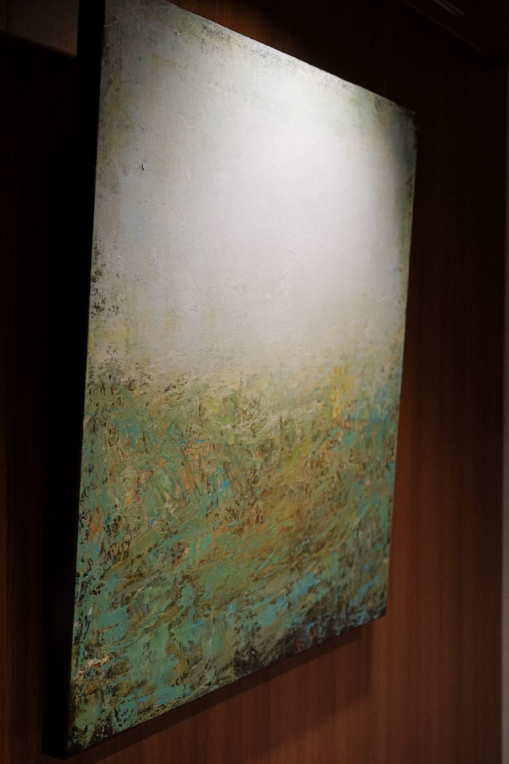 a painting hanging on a wall in a room