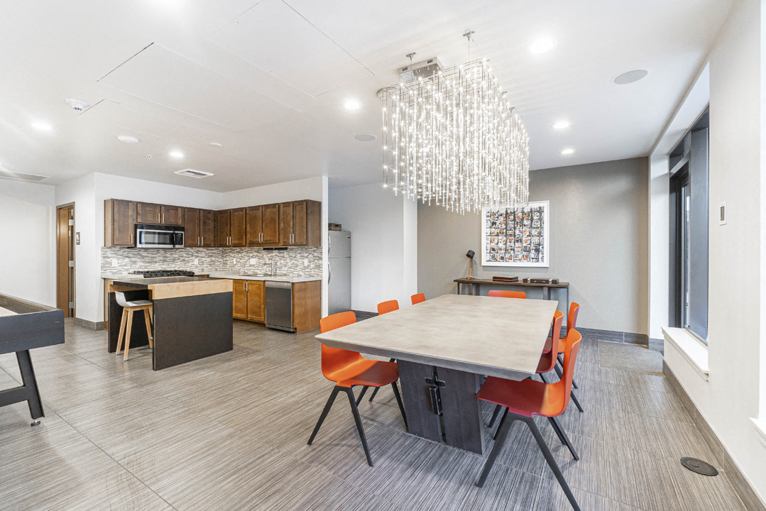 a dining room table and chairs in a room with a kitchen
