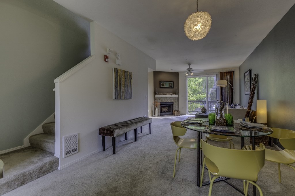 a dining room and living room with a table and chairs