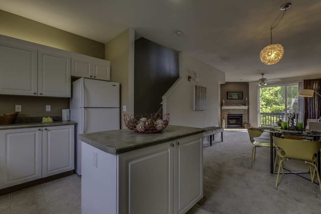 a kitchen with white cabinets and a counter top