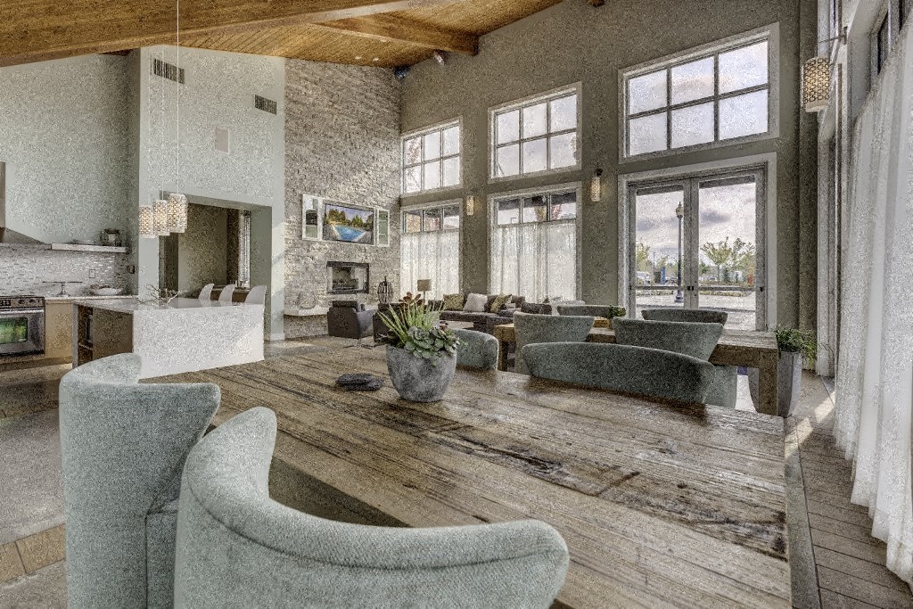 a large living room with a large wooden table and chairs