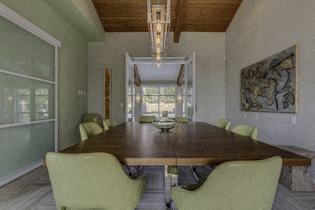 a dining room with a long wooden table and chairs