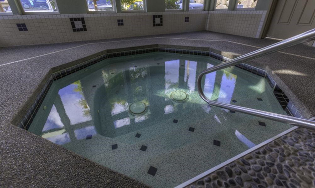 the inside of an indoor swimming pool with water in it