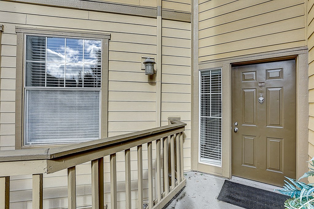 the front door of a home with a porch