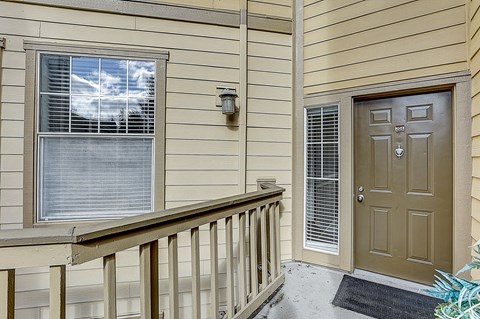 the front door of a home with a porch