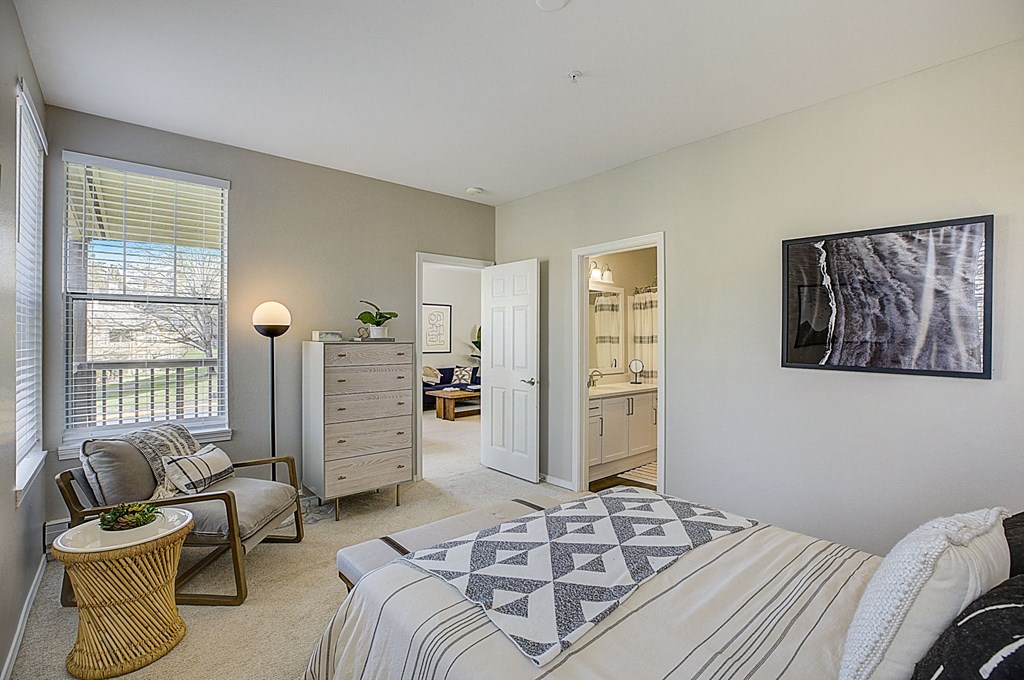 a bedroom with a bed and a chair and a closet