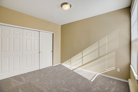 an empty room with a closet and a door