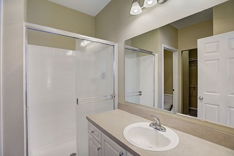 an empty bathroom with a sink and a shower