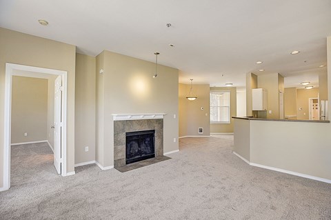 an empty living room with a fireplace