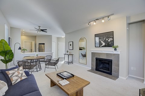 a living room with a fireplace and a table with chairs