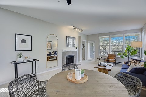 a living room with a wooden table and a fireplace