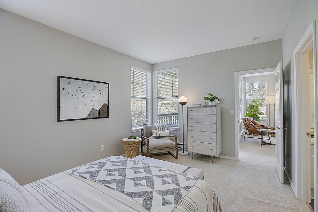 a bedroom with a bed and a dresser      and a