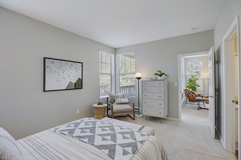 a bedroom with a bed and a dresser      and a