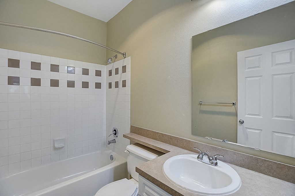 a bathroom with a sink toilet and a bath tub