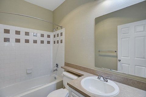 a bathroom with a sink toilet and a bath tub
