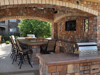 Outdoor Kitchen and BBQ Area By Pool at Centennial CO Apartments