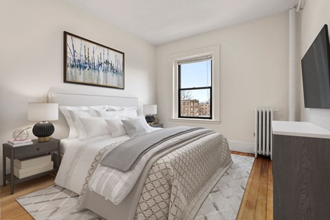 a bedroom with a large bed and a window