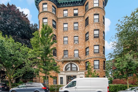 a large brick building with cars parked in front of it