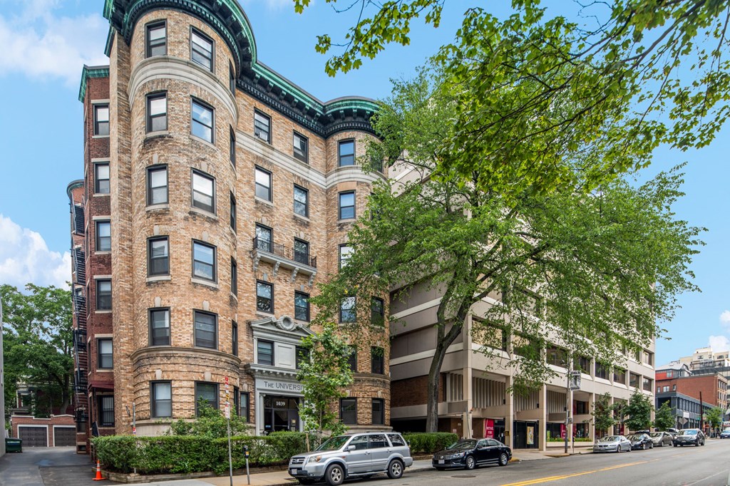 a large brick building with cars parked in front of it