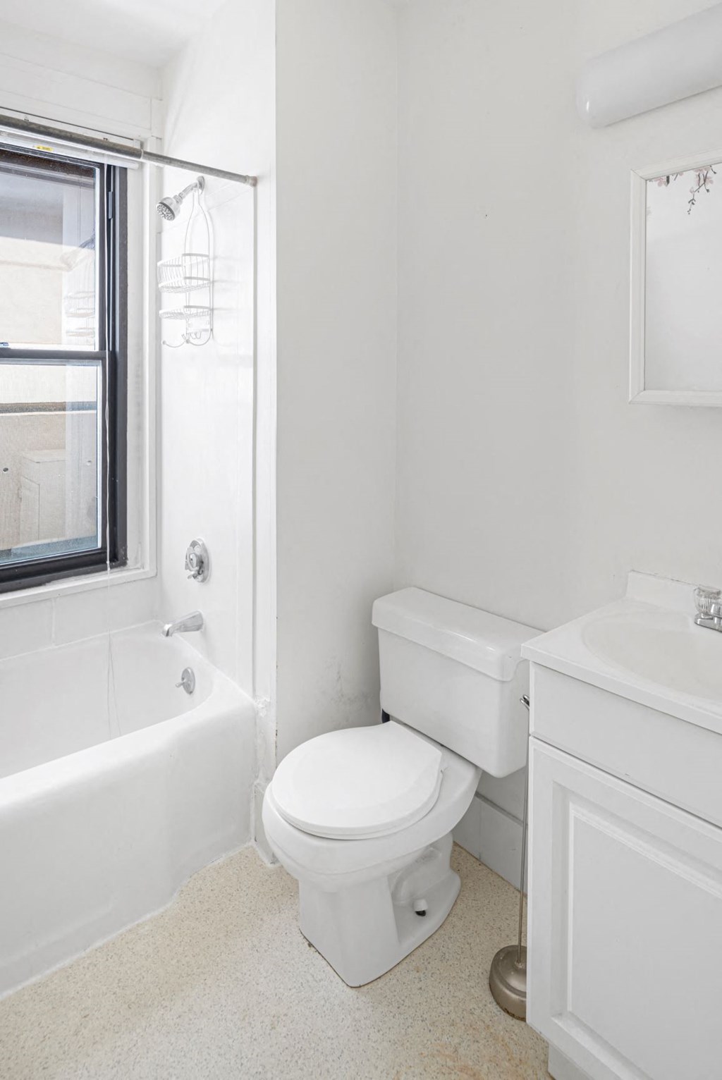 a white bathroom with a toilet and a tub