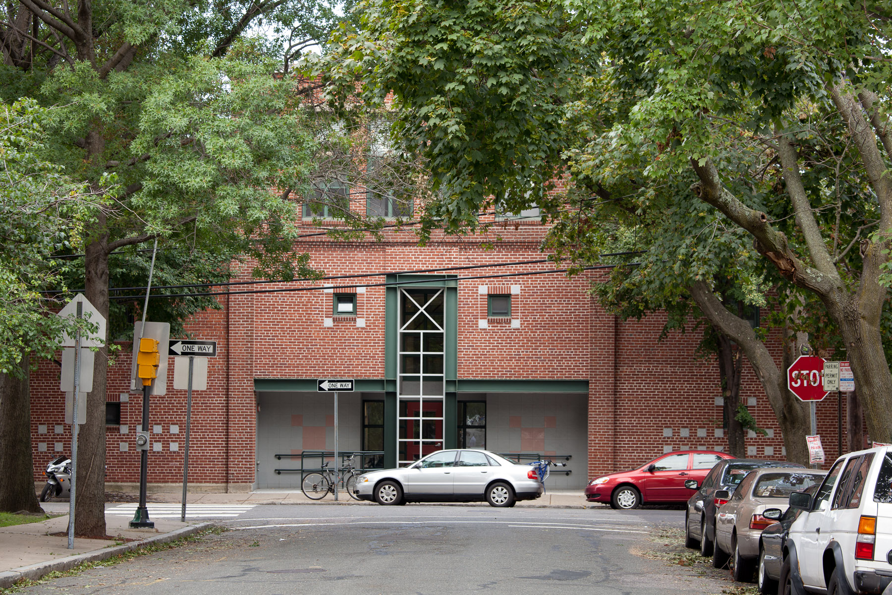 a red brick building with cars parked in front of it