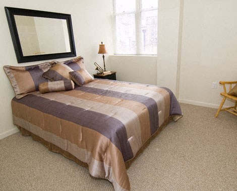 a bedroom with a bed and a mirror