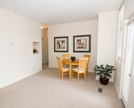 a dining room with a table and chairs
