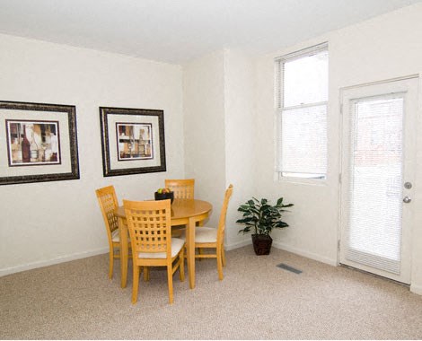 a dining room with a table and chairs