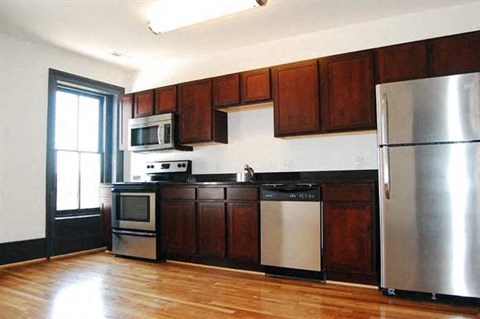 a kitchen with stainless steel appliances and wooden cabinets