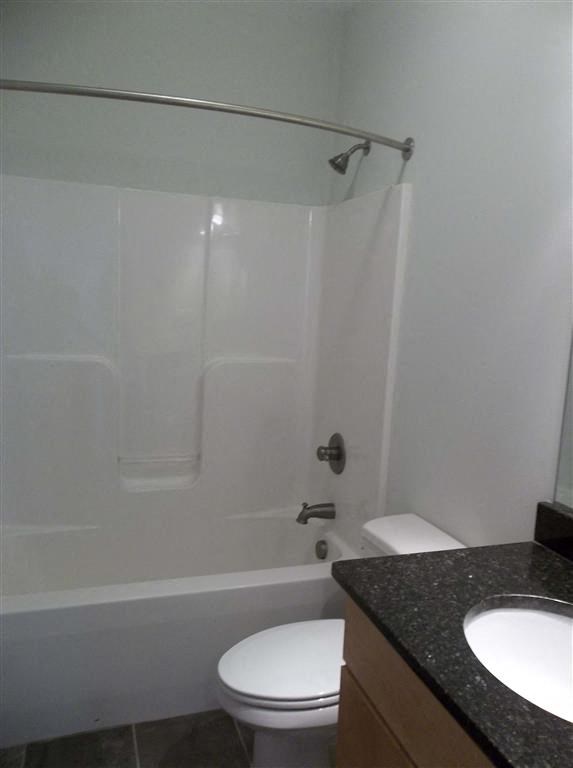 a bathroom with a toilet and a tub and a sink