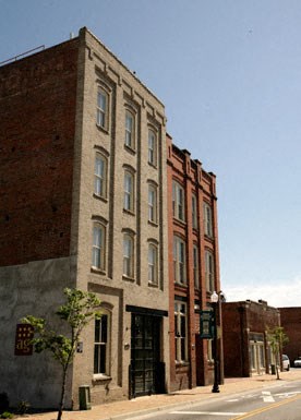a tall brick building on the side of a street